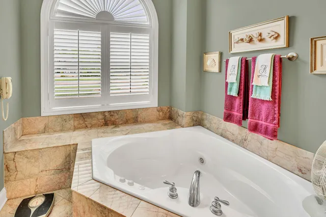 a view of an empty room with window and cabinet