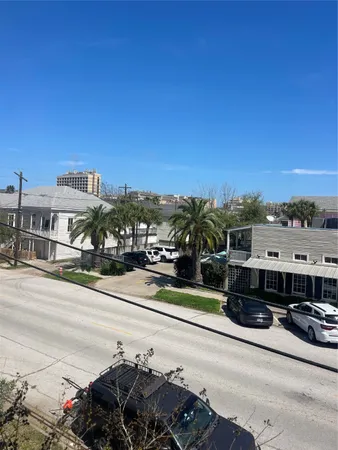 a view of a street with a car parked in front of it