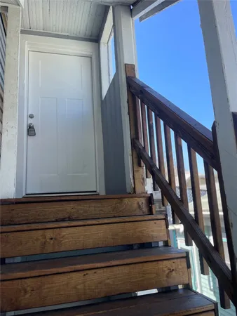 a view of staircase with wooden floor and white walls