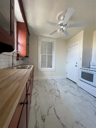 a view of a kitchen with a sink and a window