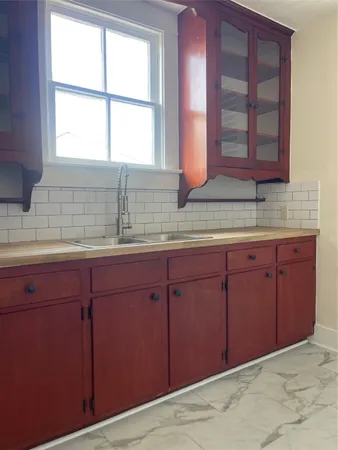 a kitchen with granite countertop cabinets and window