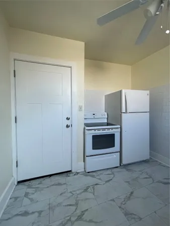 a kitchen with a stove and a refrigerator