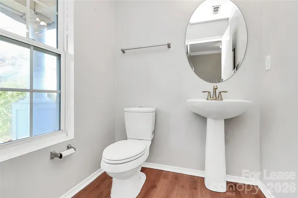 a bathroom with a sink toilet and a mirror