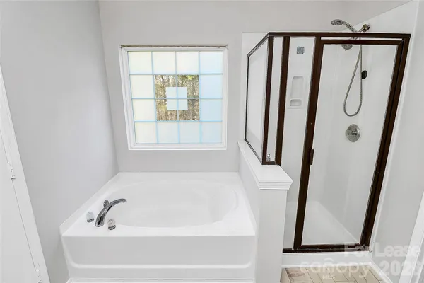 a bathroom with bathtub and a shower
