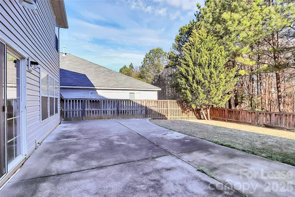 a view of backyard with small cabin and wooden fence