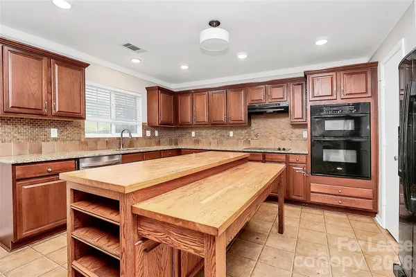 a kitchen with a refrigerator a stove and a sink