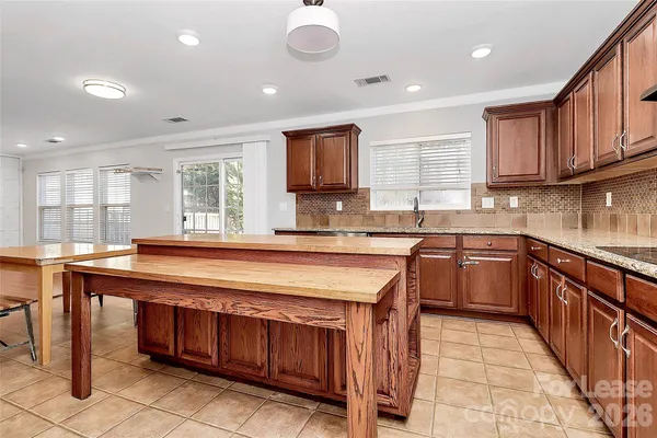 a kitchen with stainless steel appliances granite countertop wooden cabinets a sink and a stove