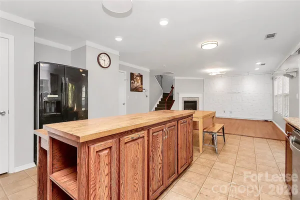 a kitchen with stainless steel appliances granite countertop a sink and a refrigerator