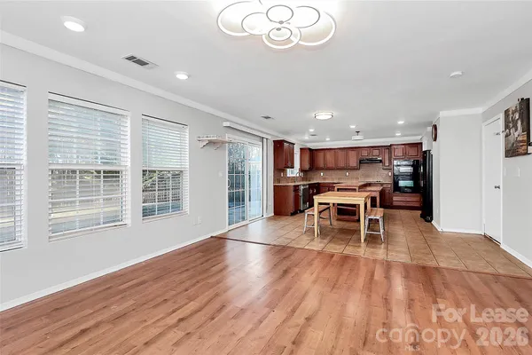 a view of a room with wooden floor and windows