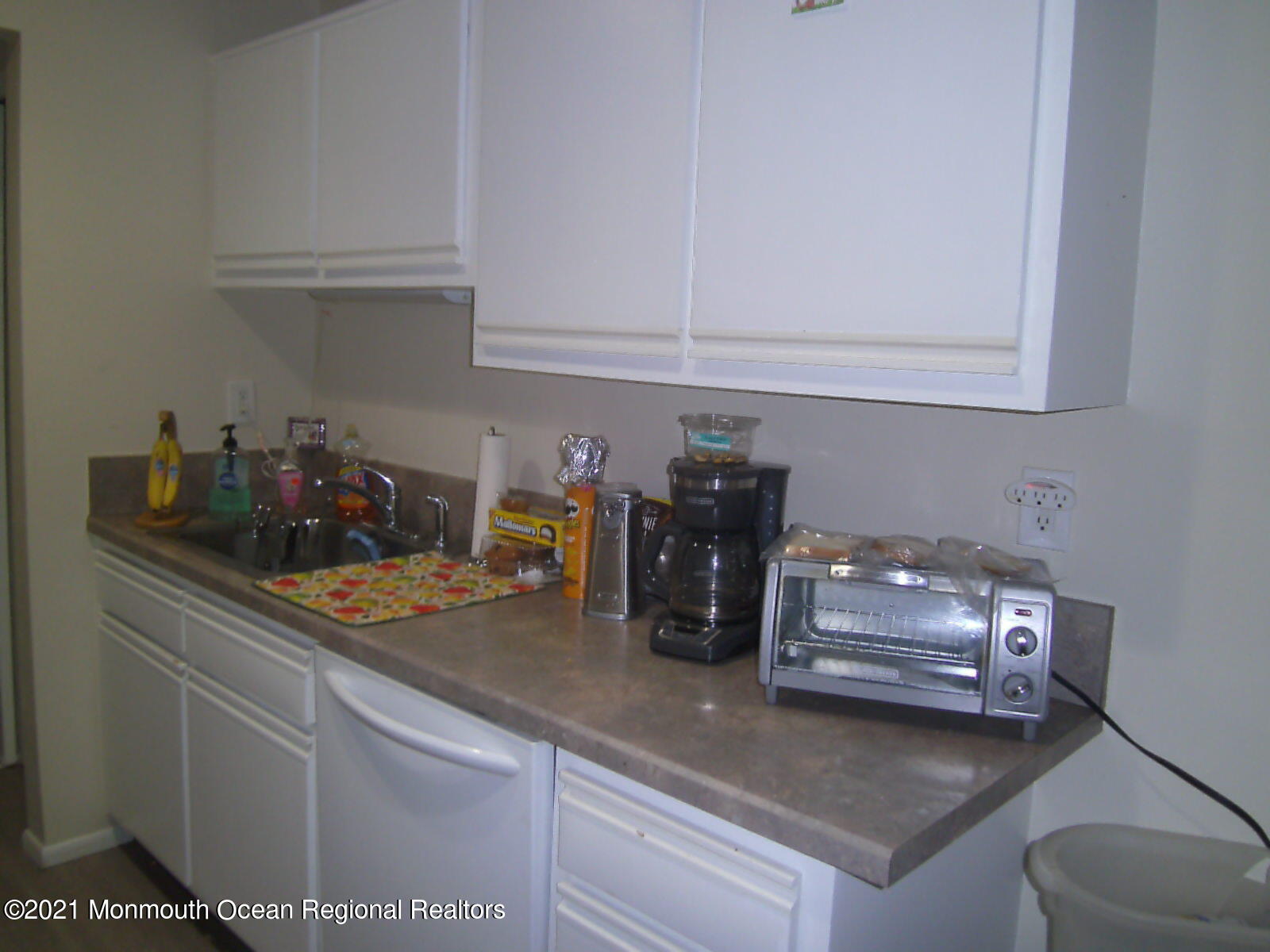 41 Meadow Green Circle, Unit E Manalapan, NJ 07726 - Photo 3 of 9 a kitchen with a sink and cabinets