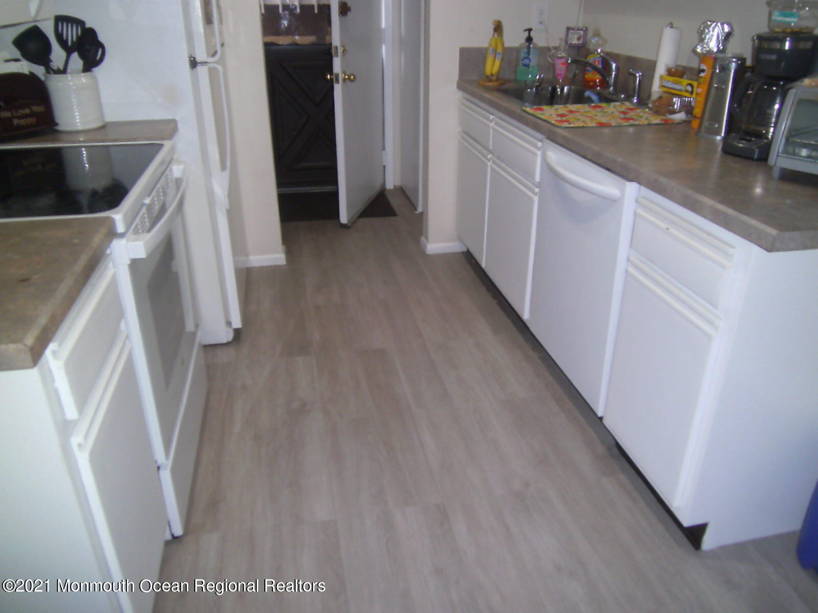 41 Meadow Green Circle, Unit E Manalapan, NJ 07726 - Photo 4 of 9 a kitchen with a sink and refrigerator