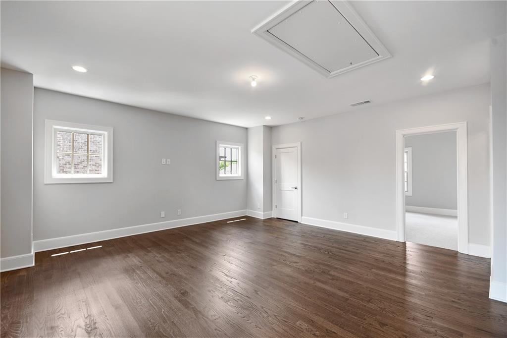 3520 Vermillion View Suwanee, GA 30024 - Photo 28 of 45 an empty room with wooden floor and windows