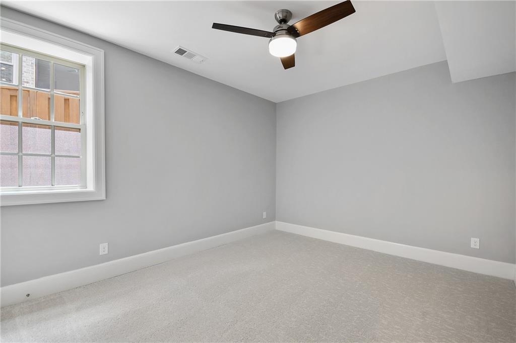 3520 Vermillion View Suwanee, GA 30024 - Photo 36 of 45 an empty room with a window and ceiling fan