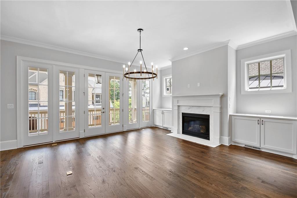3520 Vermillion View Suwanee, GA 30024 - Photo 8 of 45 a view of an empty room with wooden floor and a window