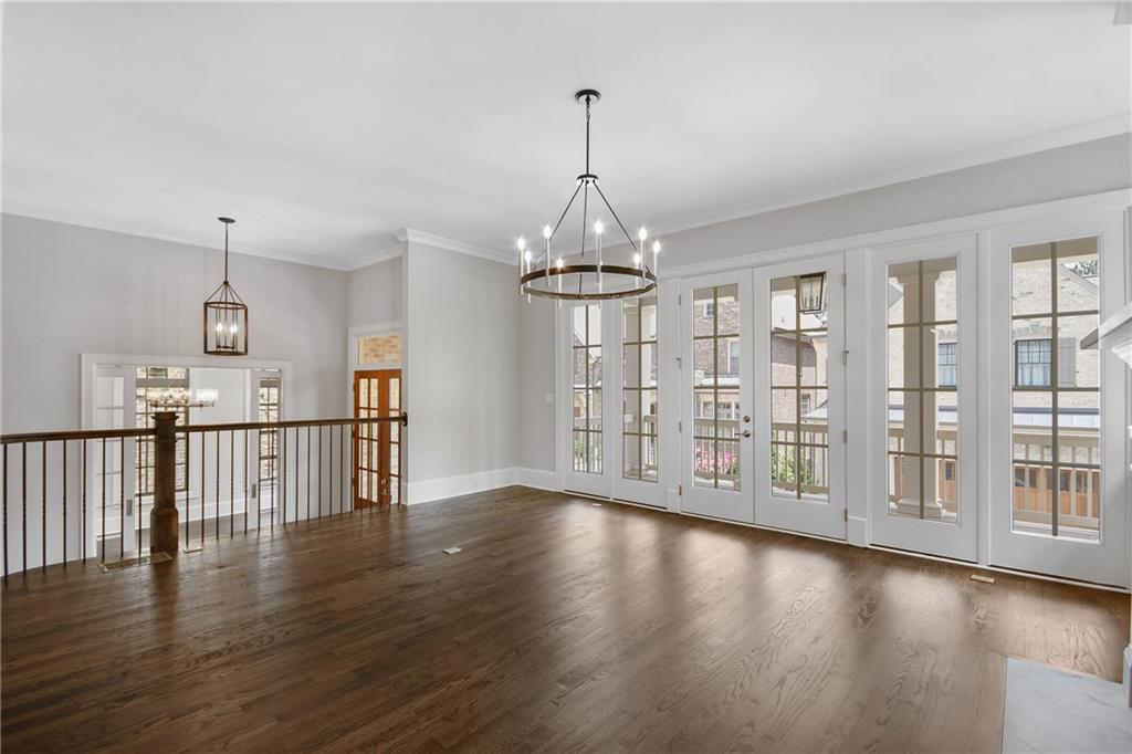 3520 Vermillion View Suwanee, GA 30024 - Photo 9 of 45 a view of a room with wooden floor windows and a chandelier