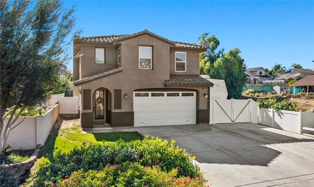 14155 Meadowlands Drive Riverside, CA 92503 - Photo 1 of 1 a front view of a house with a yard and garage