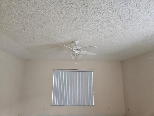 a bathroom with a tub a sink and a window