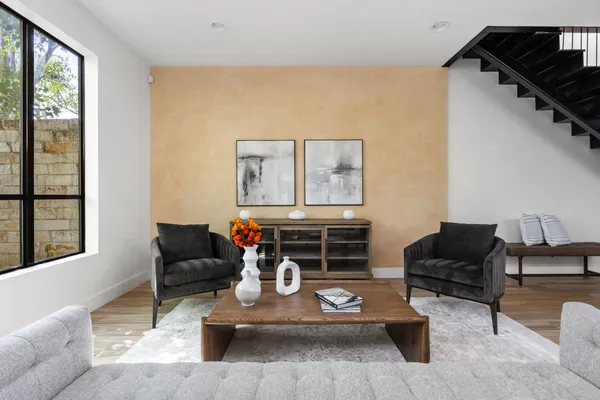 a living room with furniture and wooden floor