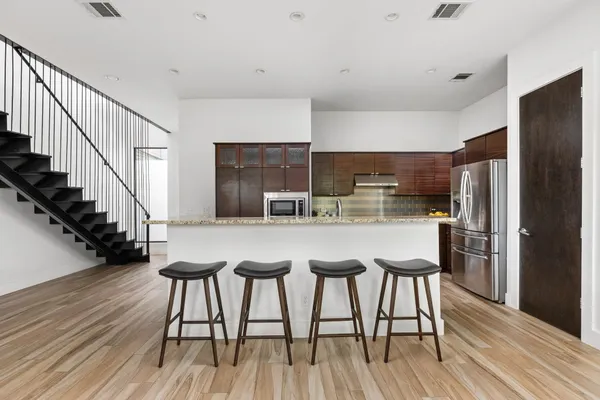 a kitchen with stainless steel appliances granite countertop a stove and a refrigerator