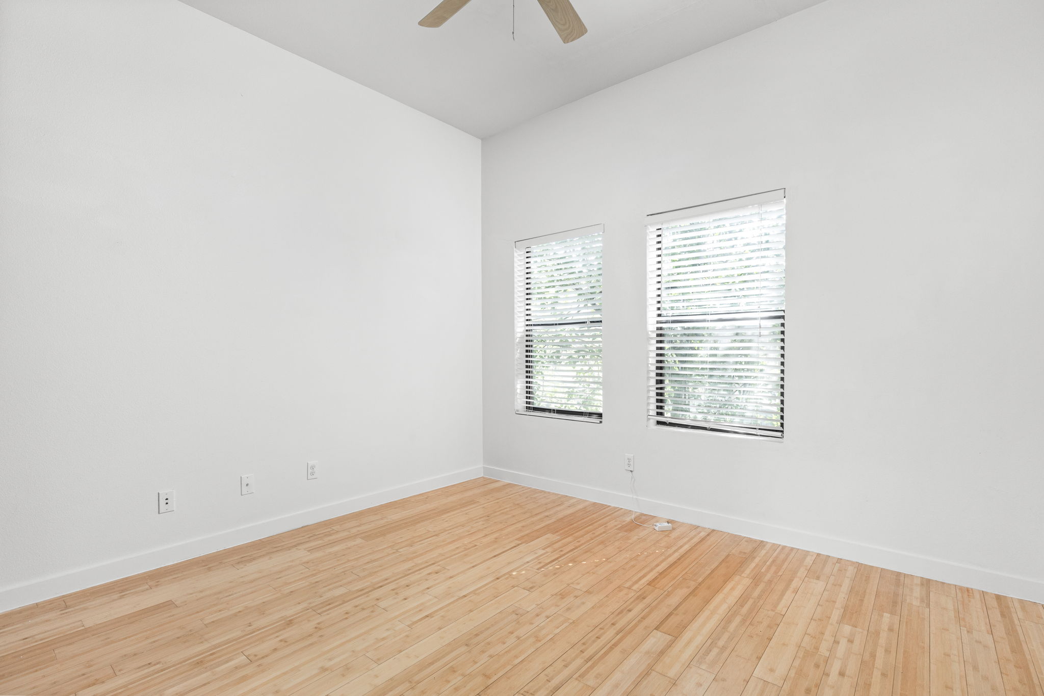 1907 West 30th Street Austin, TX 78703 - Photo 22 of 35 an empty room with wooden floor and windows