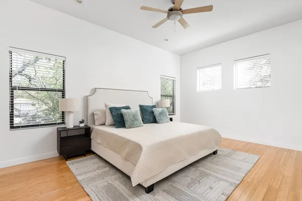a bedroom with a bed and ceiling fan