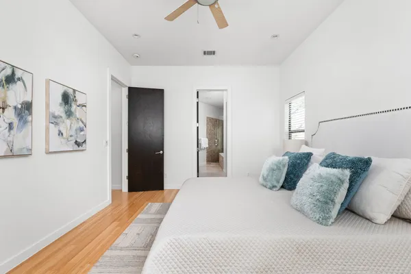 a spacious bathroom with a tub sink shower and mirror