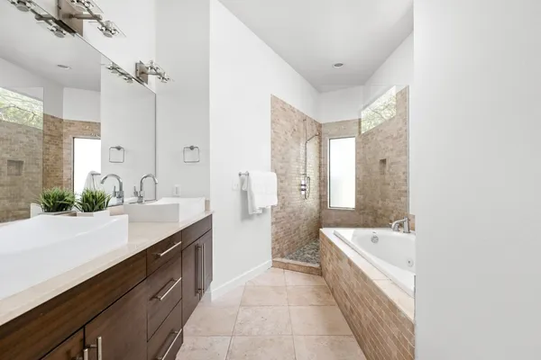 a bathroom with a sink double vanity granite and a mirror
