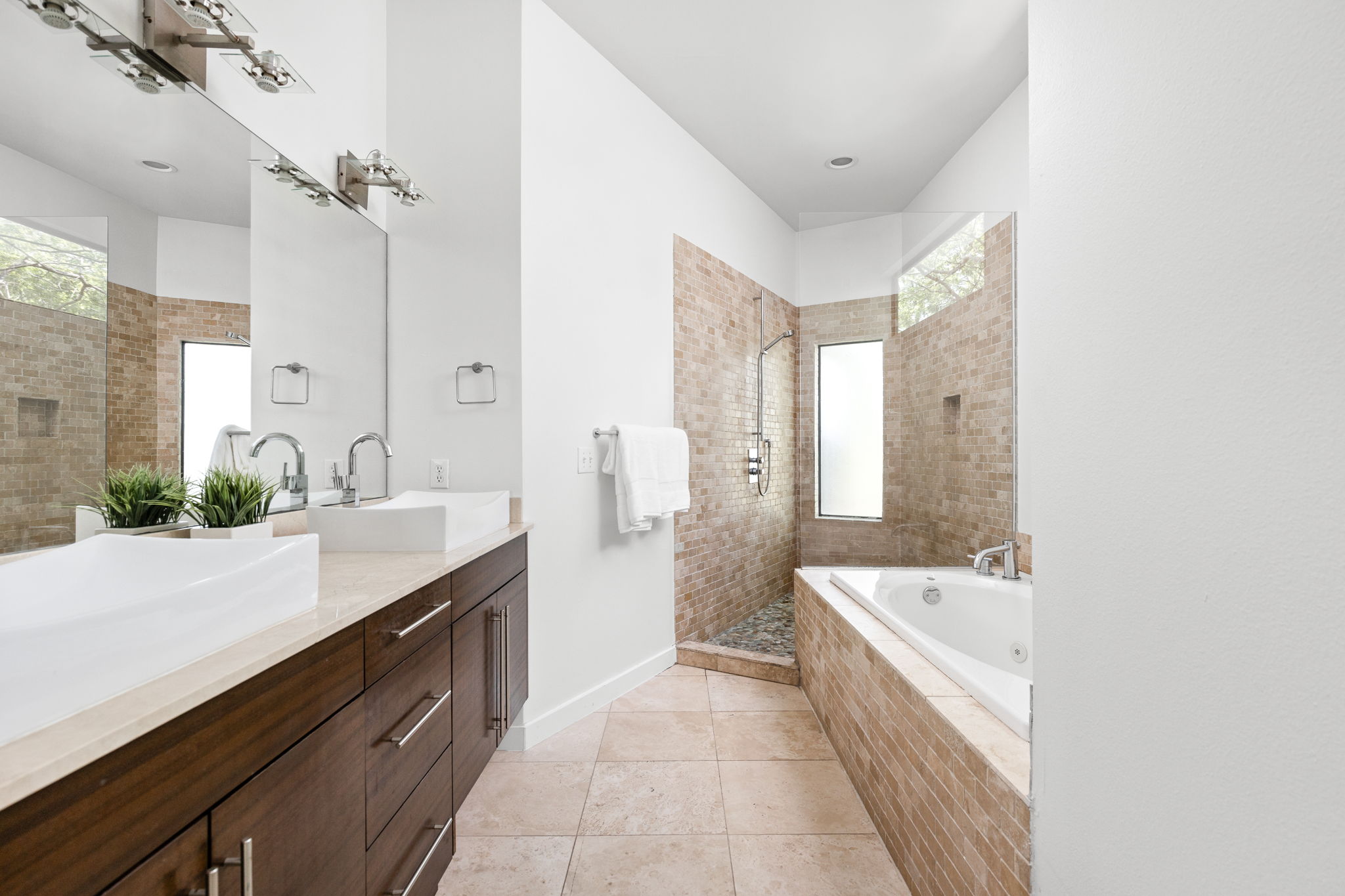 1907 West 30th Street Austin, TX 78703 - Photo 25 of 35 a spacious bathroom with a tub sink shower and mirror