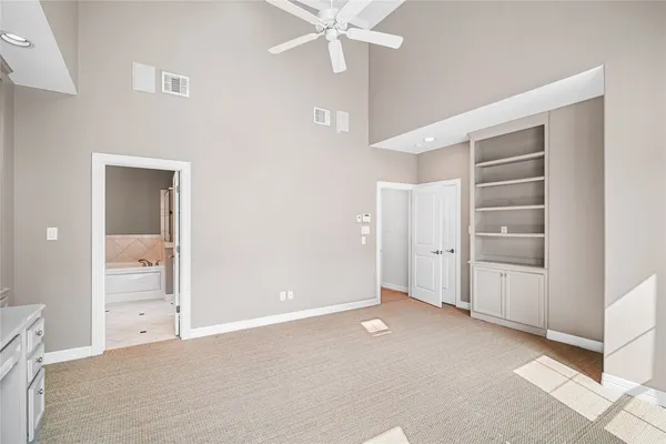 an empty room with closet and entryway