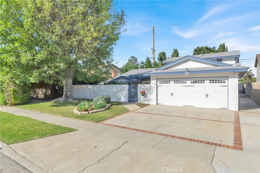 a view of a house with a backyard and a garage