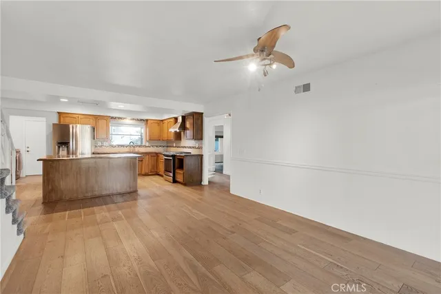 a view of kitchen with granite countertop cabinets and refrigerator