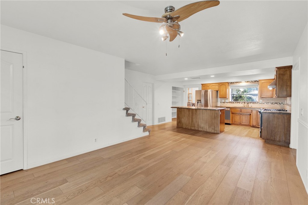 13381 Epping Way Tustin, CA 92780 - Photo 14 of 52 a view of a kitchen with a sink a ceiling fan and wooden floor