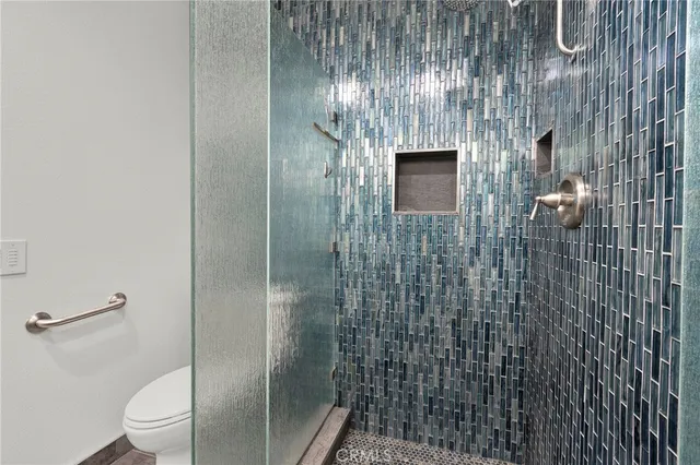 a bathroom with a toilet and a shower