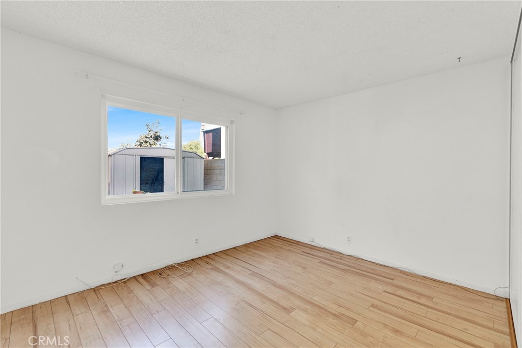 13381 Epping Way Tustin, CA 92780 - Photo 21 of 52 a view of a room with wooden floor and white walls