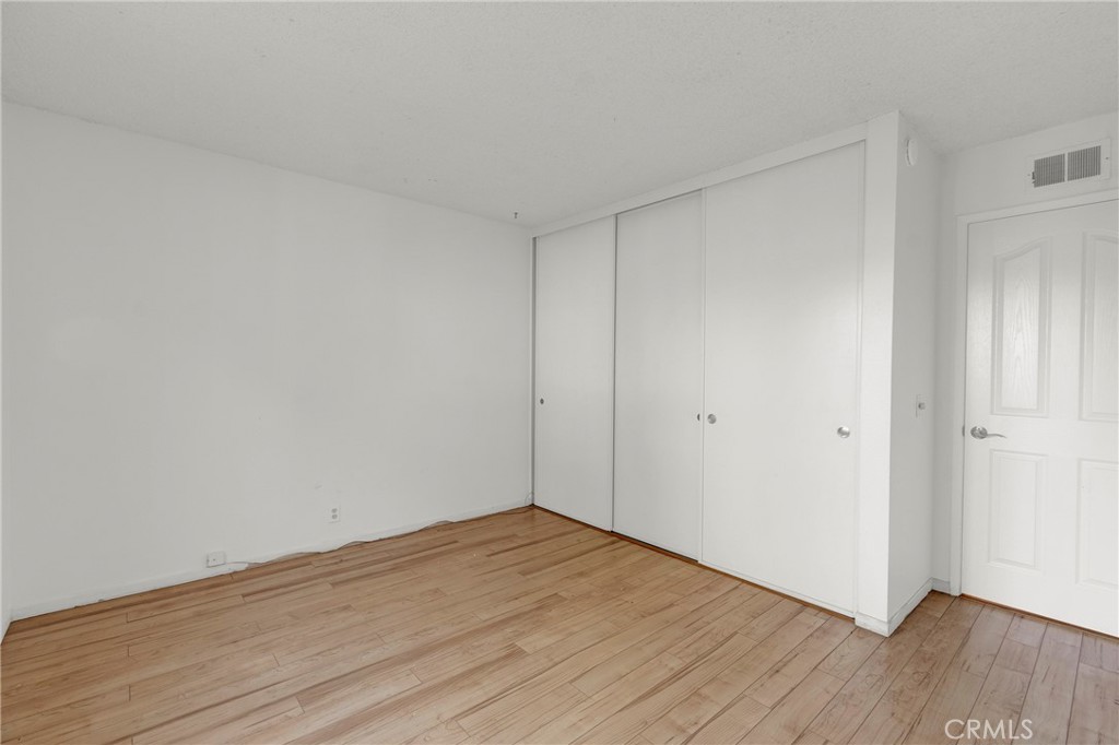13381 Epping Way Tustin, CA 92780 - Photo 22 of 52 a view of an empty room with wooden floor