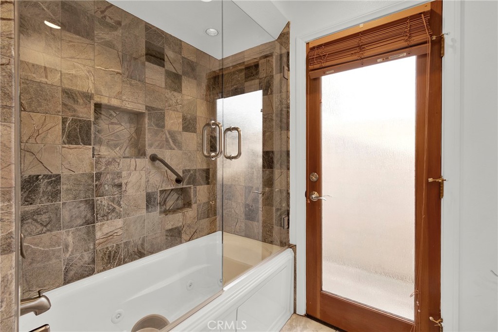 13381 Epping Way Tustin, CA 92780 - Photo 24 of 52 a bathroom with a bathtub and a shower