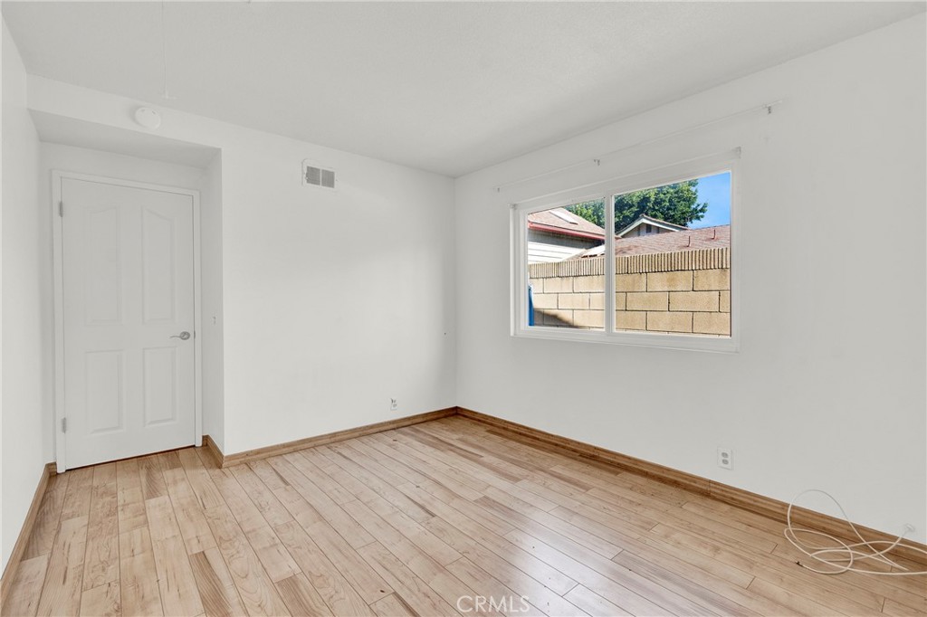 13381 Epping Way Tustin, CA 92780 - Photo 26 of 52 an empty room with wooden floor and windows