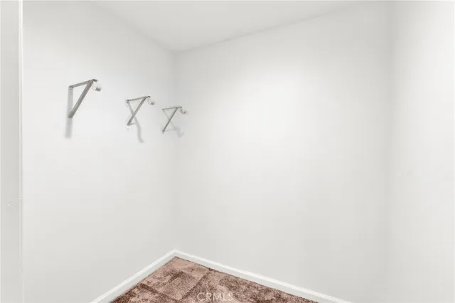 a view of a storage and utility room with washer and dryer