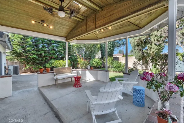 a view of a patio with table and chairs and potted plants