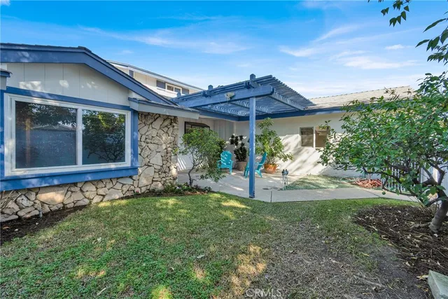 a view of a patio with a table and chairs under an umbrella