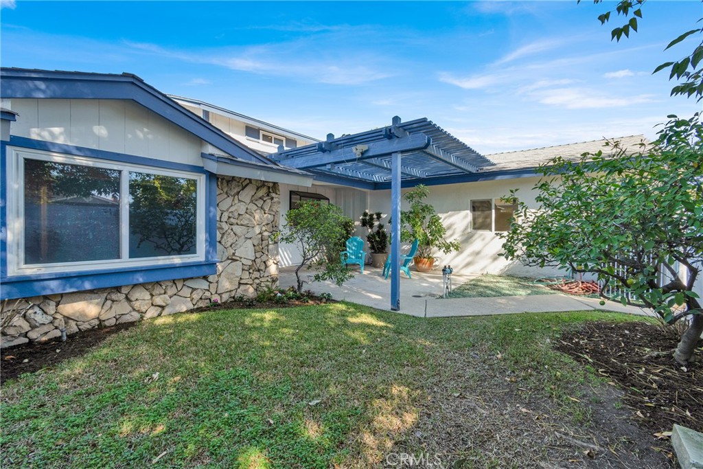 13381 Epping Way Tustin, CA 92780 - Photo 4 of 52 a view of a patio with a table and chairs under an umbrella