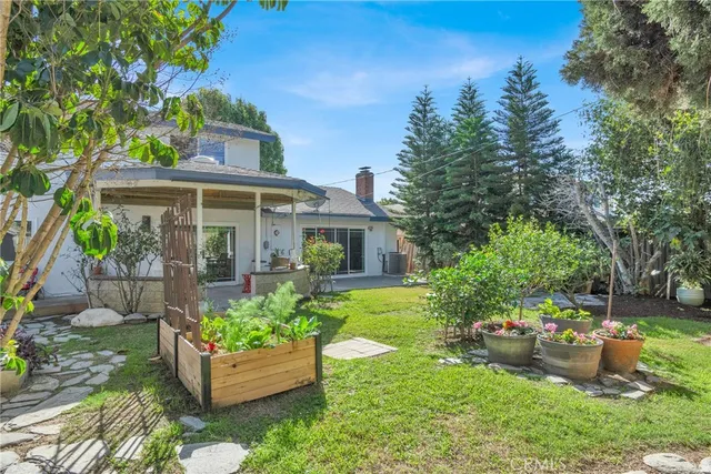 a backyard of a house with yard and outdoor seating