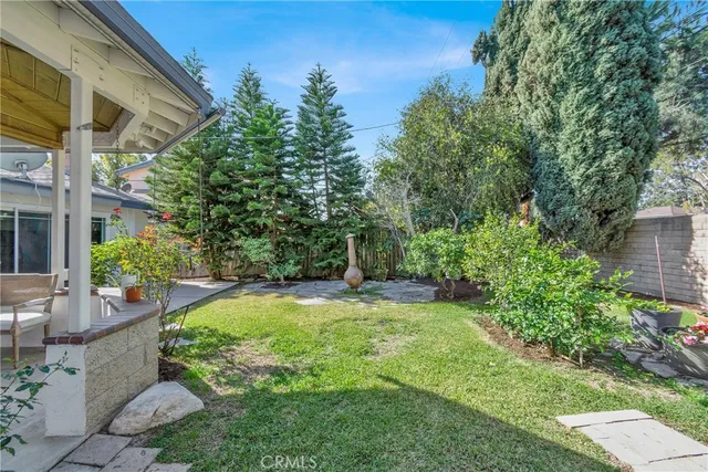 a view of an house with backyard and sitting area