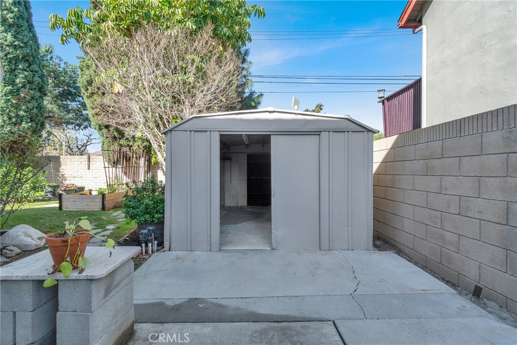 13381 Epping Way Tustin, CA 92780 - Photo 45 of 52 a view of a house with a small yard and potted plants