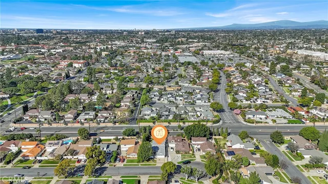 an aerial view of a residential houses with yard