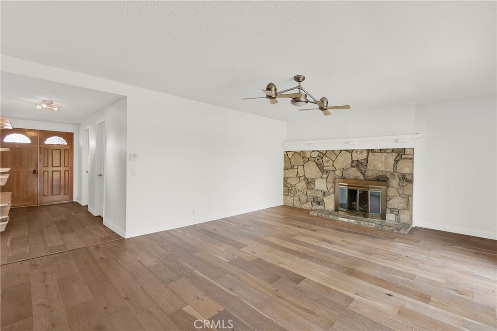 13381 Epping Way Tustin, CA 92780 - Photo 7 of 52 a view of an empty room with a fireplace and a window