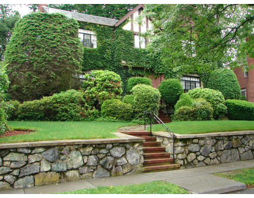 73 Welland Road Brookline, MA 02445 - Photo 1 of 12 a view of a yard with plants and a bench