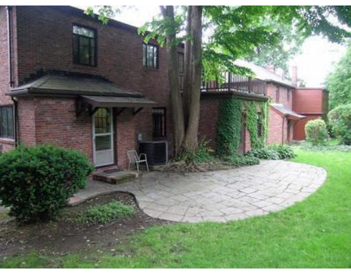 73 Welland Road Brookline, MA 02445 - Photo 11 of 12 a view of a brick house with a yard plants and large tree