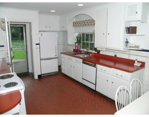 73 Welland Road Brookline, MA 02445 - Photo 7 of 12 a kitchen with white cabinets and sink