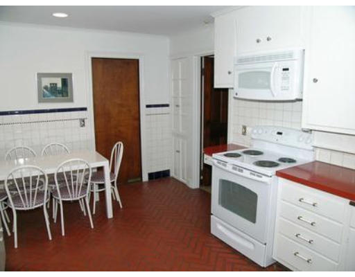 73 Welland Road Brookline, MA 02445 - Photo 8 of 12 a kitchen with a stove a table and chairs